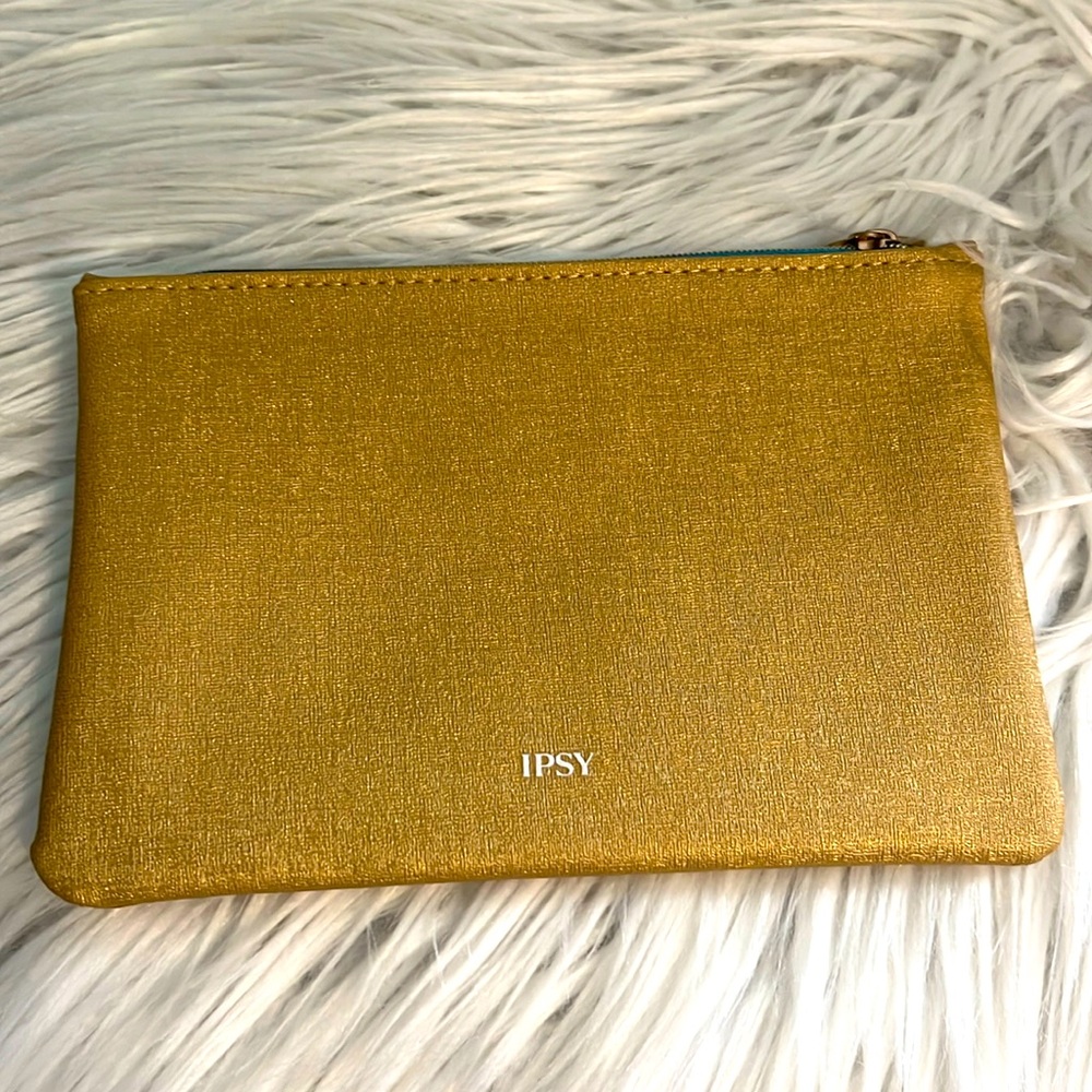 Free with purchase - IPSY Makeup bag gold with turquoise interior 5x7” Zips.